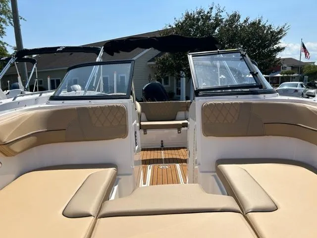 Slide: The Image of 2024 Bayliner VR4 boat interior with tan seating and open deck. - 7