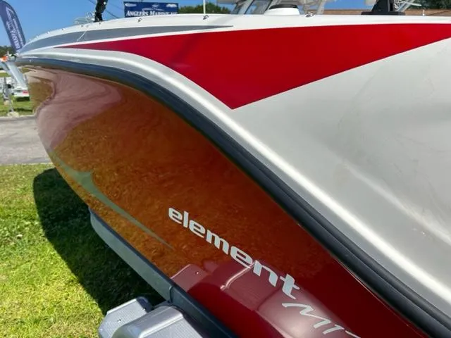 Slide: The Image of 2024 Bayliner Element M17 boat with red and white exterior design. - 4