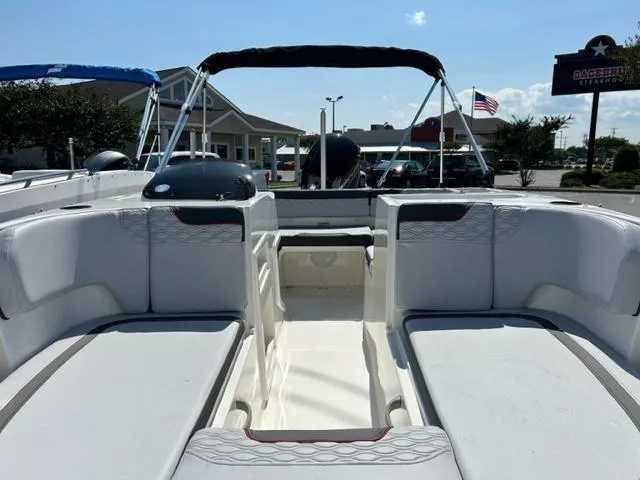 Slide: The Image of 2024 Bayliner Element M17 boat interior with white seating and black canopy. - 5