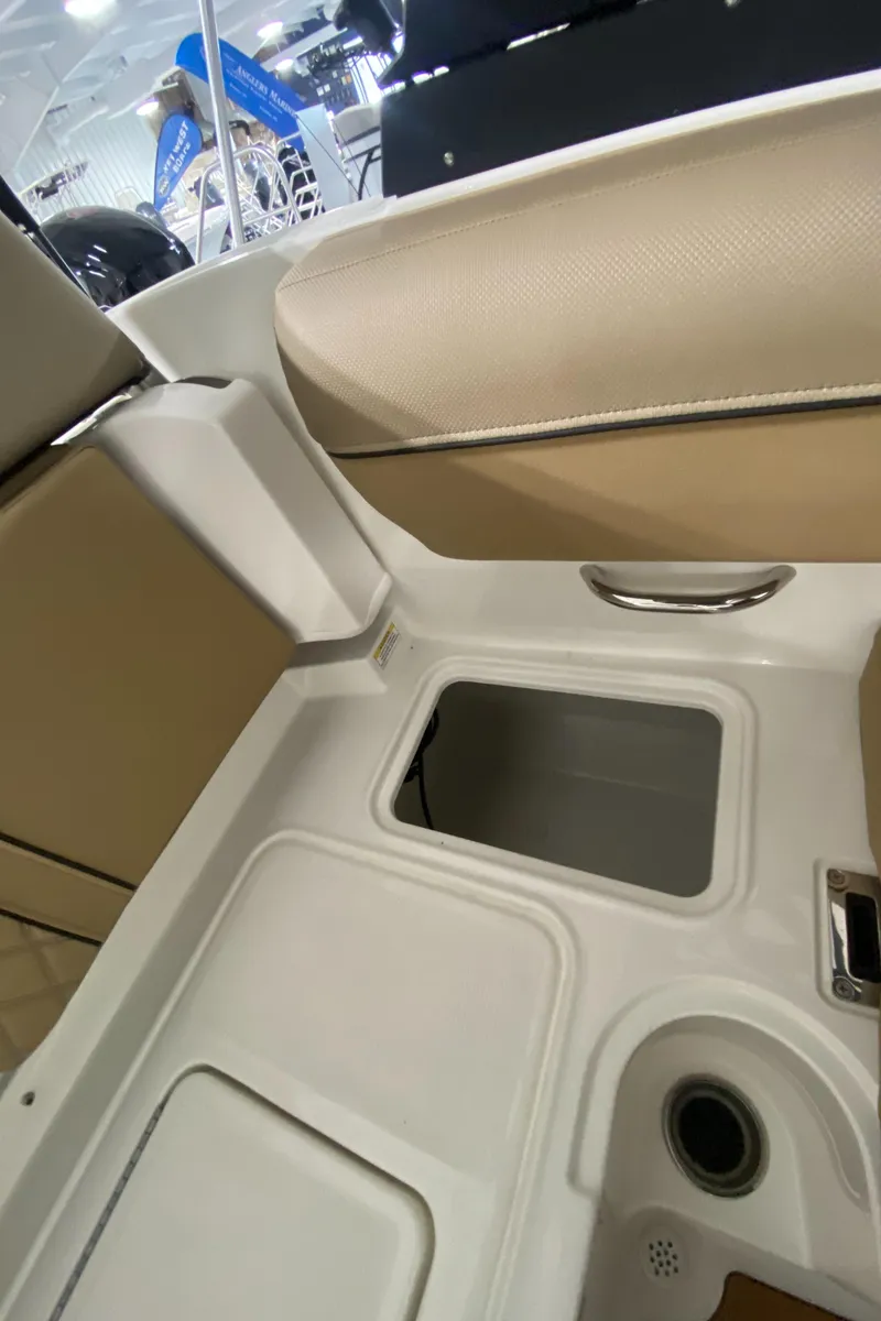 Slide: The Image of 2024 Bayliner DX2000 boat interior storage compartments and seating. - 11