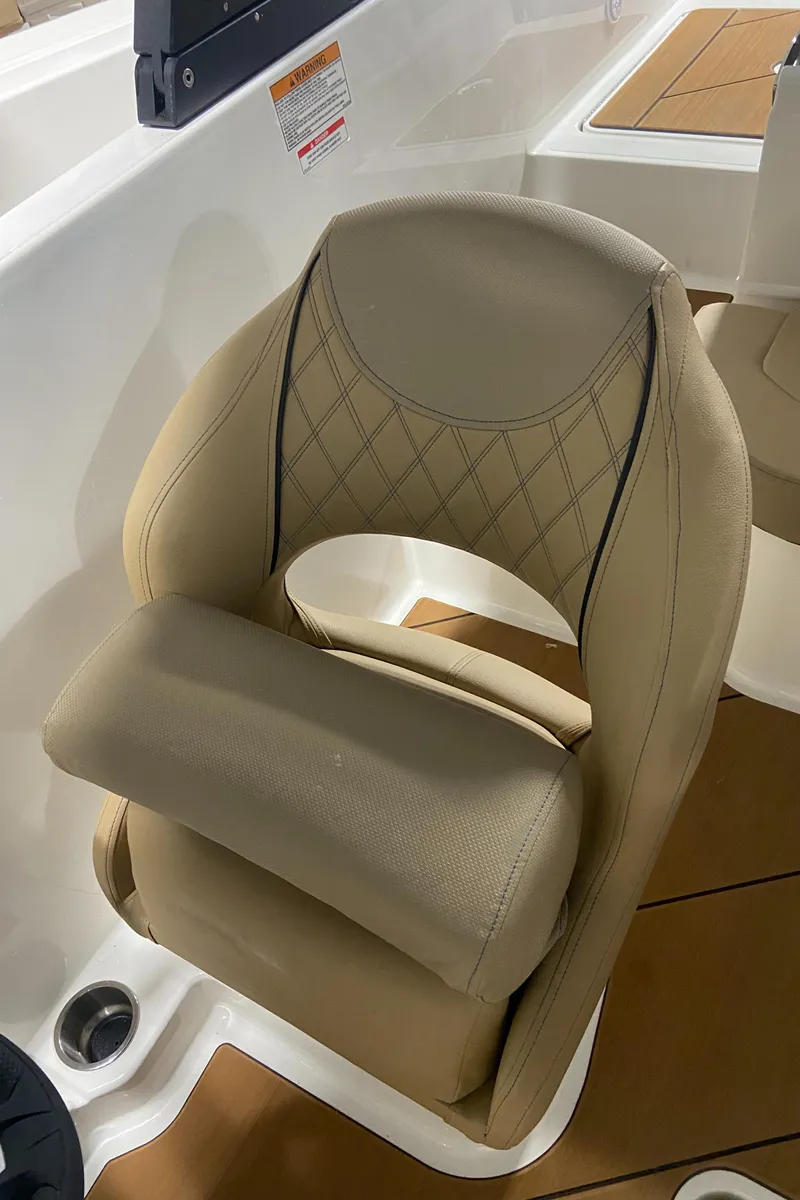 Slide: The Image of 2024 Bayliner DX2000 boat seat with beige upholstery and diamond stitching. - 17