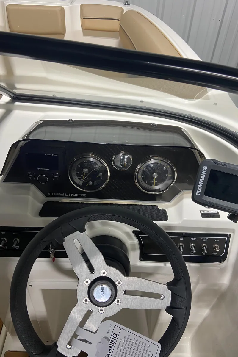 Slide: The Image of 2024 Bayliner DX2000 boat dashboard with steering wheel and instrument panel. - 19