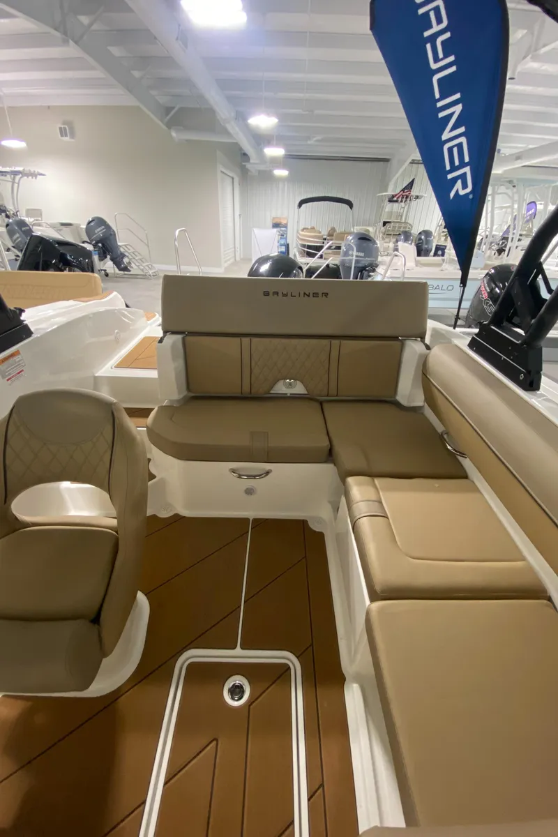 Slide: The Image of 2024 Bayliner DX2000 boat interior with tan seating and modern design. - 8