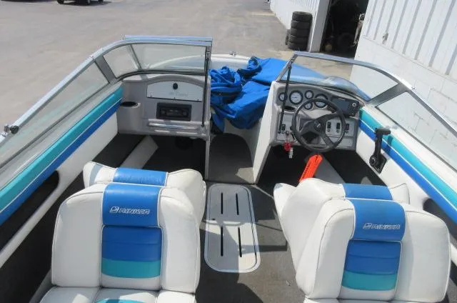 Slide: The Image of 1993 Rinker 186 Captiva boat interior with blue and white seating. - 5