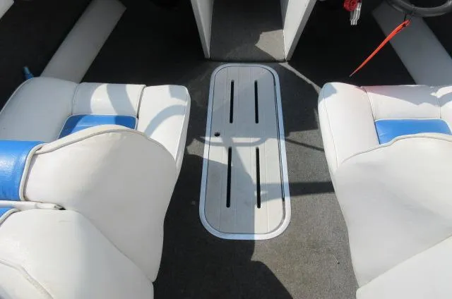 Slide: The Image of Interior of a 1993 Rinker 186 Captiva boat with white and blue seats. - 8