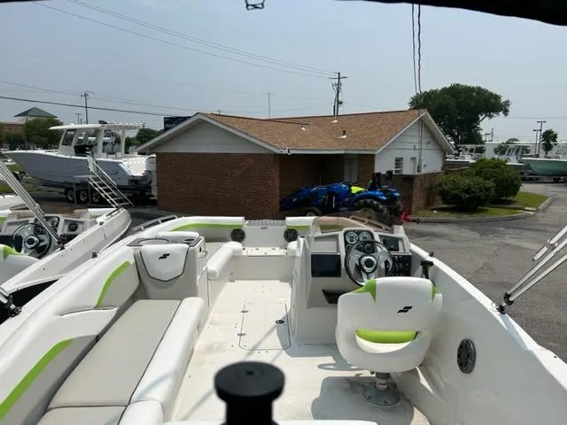 Slide: The Image of 2024 Starcraft SVX 211 Lime Green Sport boat interior with white and green seating. - 10