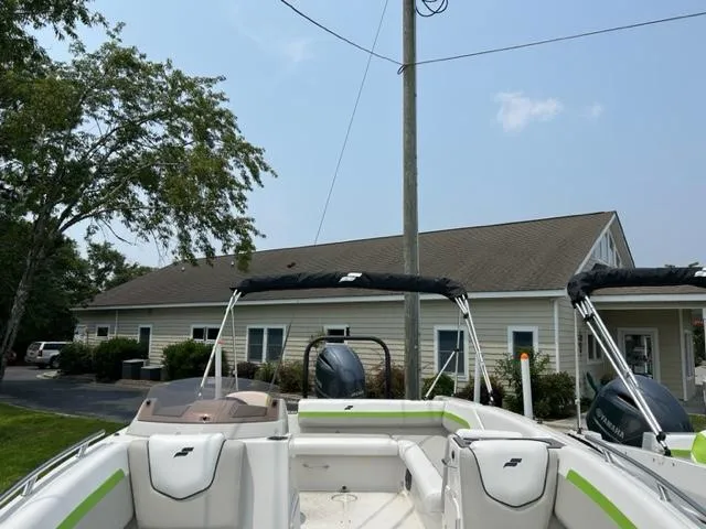 Slide: The Image of 2024 Starcraft SVX 211 Lime Green Sport boat, docked near a building. - 7