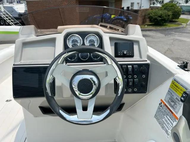 Slide: The Image of 2024 Starcraft SVX 211 Lime Green Sport boat dashboard and steering wheel. - 9