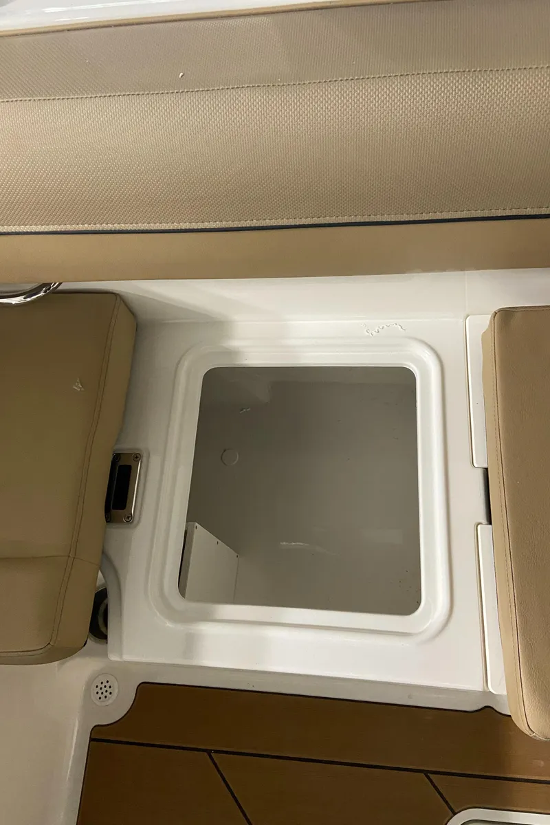 Slide: The Image of 2024 Bayliner DX2000 boat storage compartment with beige seating. - 10
