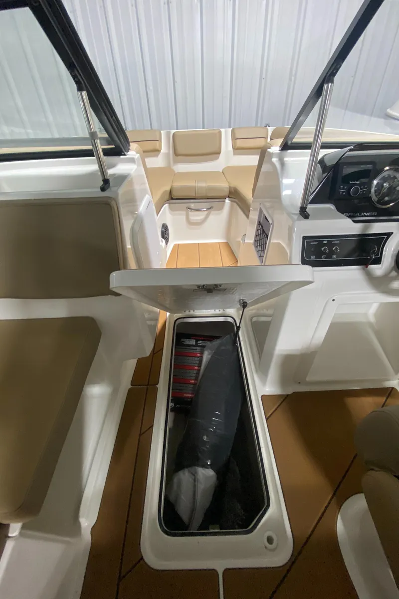 Slide: The Image of 2024 Bayliner DX2000 boat interior with open storage compartment. - 15