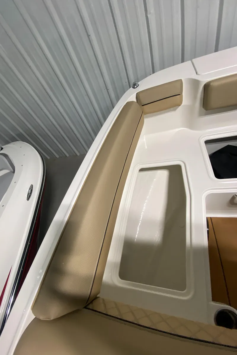 Slide: The Image of 2024 Bayliner DX2000 boat interior with beige seating and storage compartments. - 24