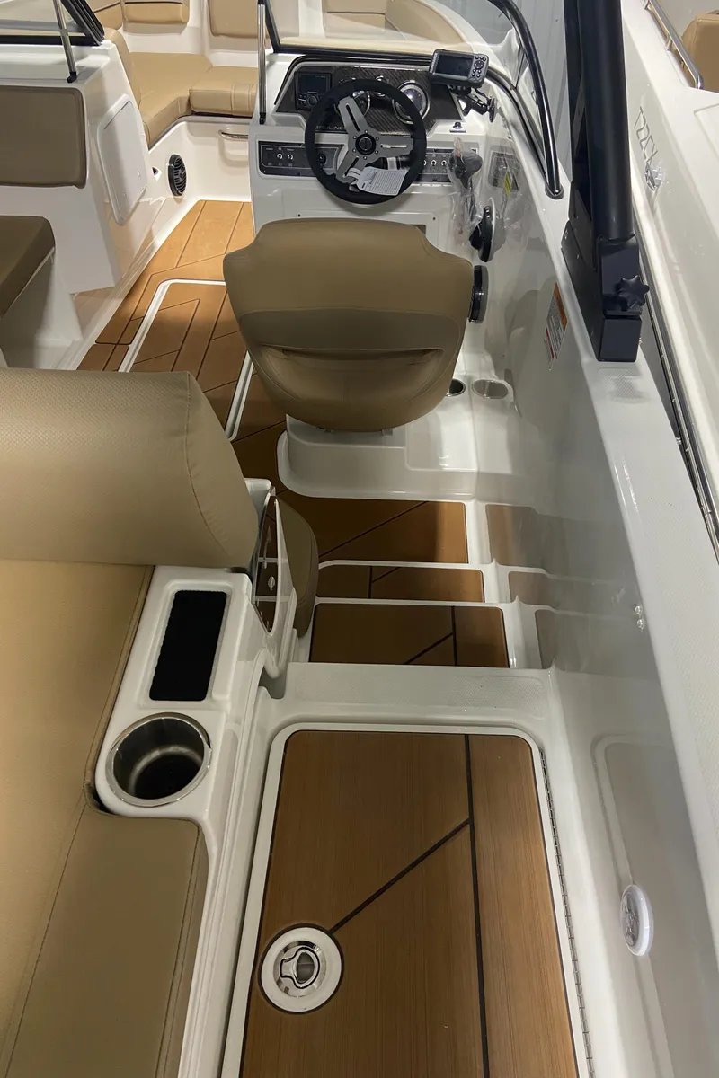 Slide: The Image of 2024 Bayliner DX2000 boat interior with tan seats and modern dashboard. - 4