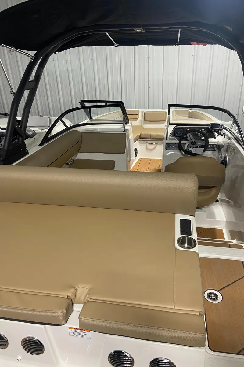 Slide: The Image of 2024 Bayliner DX2000 boat interior with tan seating and modern design. - 6