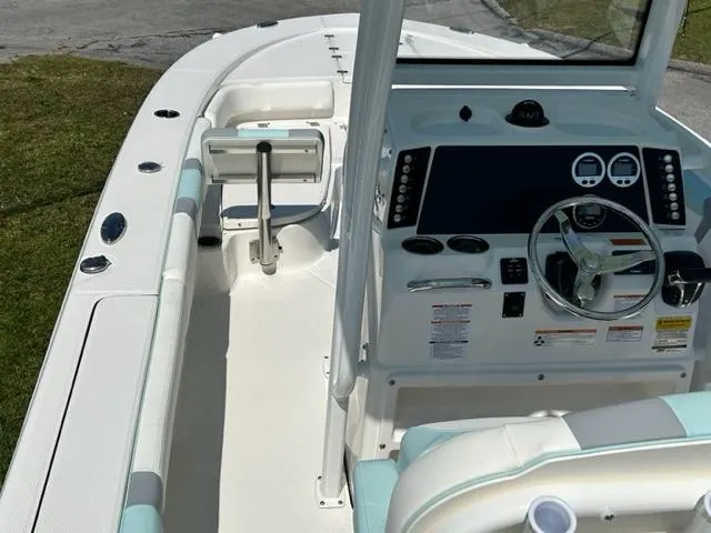 Slide: The Image of 2024 Robalo 246 Cayman boat interior with helm and seating. - 10