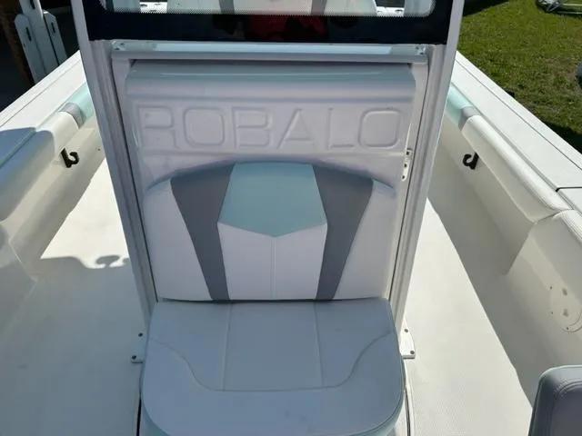 Slide: The Image of 2024 Robalo 246 Cayman boat interior with cushioned seating. - 15