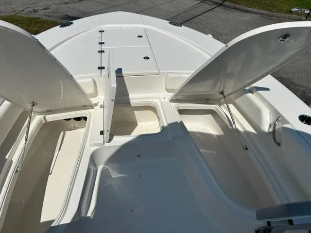 Slide: The Image of 2024 Robalo 246 Cayman boat with open storage compartments. - 14