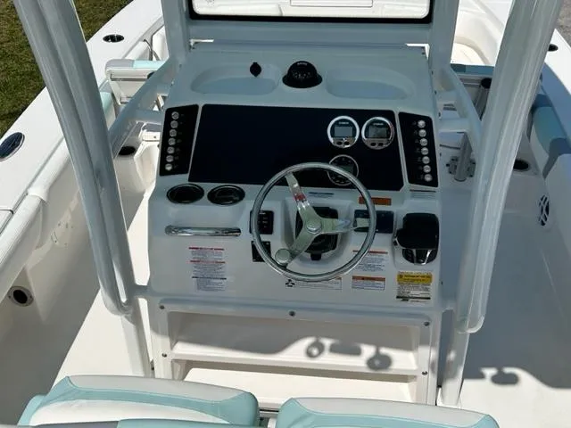 Slide: The Image of 2024 Robalo 246 Cayman boat console with steering wheel and controls. - 8