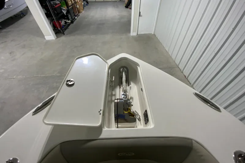 Slide: The Image of 2024 Key West 263 FS boat anchor storage compartment in a garage. - 25
