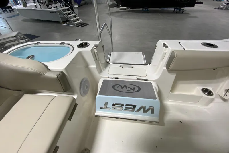 Slide: The Image of 2024 Key West 263 FS boat interior with seating and storage compartments. - 28