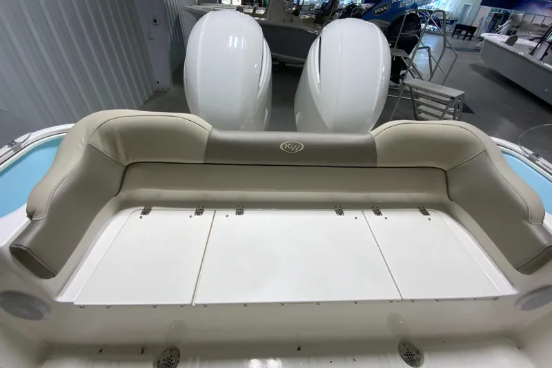 Slide: The Image of 2024 Key West 263 FS boat with dual outboard motors and cushioned seating. - 9
