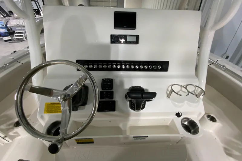 Slide: The Image of 2024 Key West 263 FS boat dashboard with steering wheel and controls. - 13
