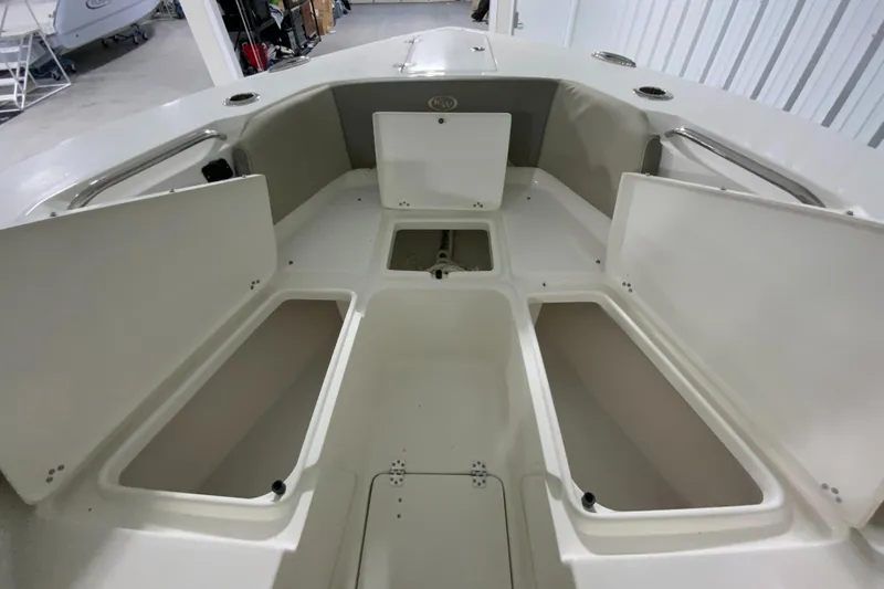Slide: The Image of 2024 Key West 263 FS boat with open storage compartments. - 24