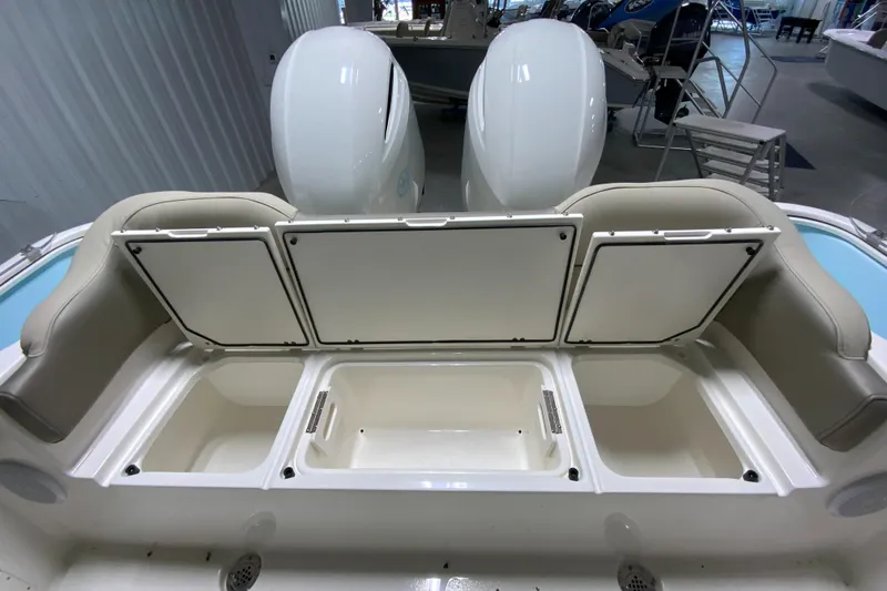 Slide: The Image of 2024 Key West 263 FS boat with open storage compartments and twin engines. - 30