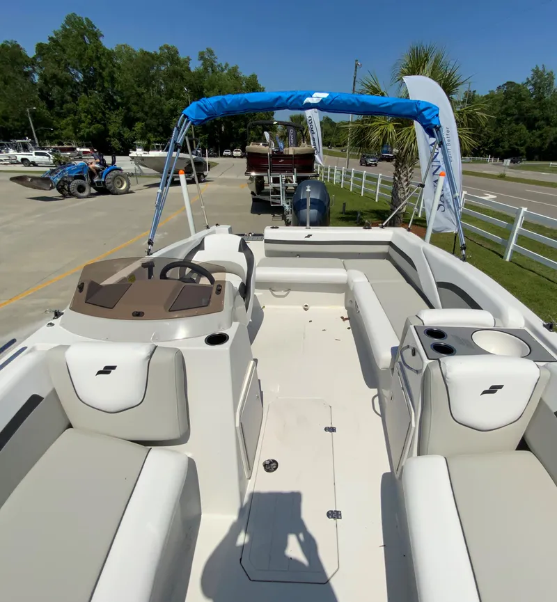 Slide: The Image of 2024 Starcraft SVX 191 boat with blue canopy and spacious seating. - 7