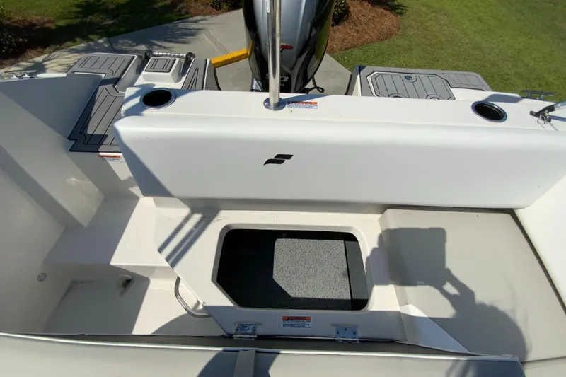 Slide: The Image of 2024 Starcraft SVX 171 boat interior with storage compartments and seating. - 13