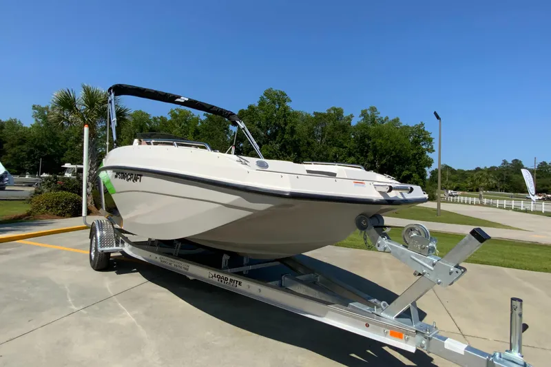 Slide: The Image of 2024 Starcraft SVX 171 boat on a trailer in a sunny outdoor setting. - 2