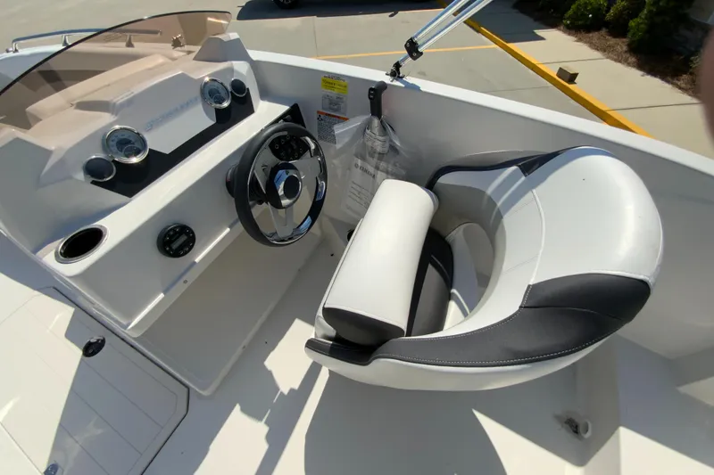 Slide: The Image of 2024 Starcraft SVX 171 boat cockpit with steering wheel and captain's chair. - 9