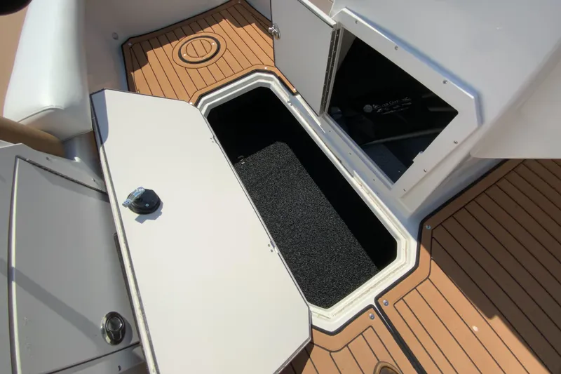 Slide: The Image of 2023 Starcraft SVX 211 boat storage compartment with open hatch. - 14