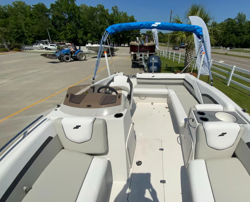 Slide: The Image of 2023 Starcraft SVX 211 boat with spacious seating and blue canopy. - 5