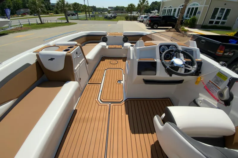 Slide: The Image of 2023 Starcraft SVX 211 boat interior with tan seating and wood-like flooring. - 8