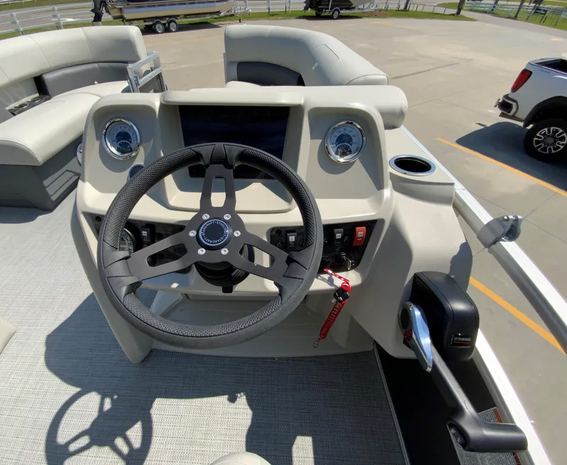 Slide: The Image of 2024 Starcraft LX20 R boat helm with steering wheel and controls. - 13