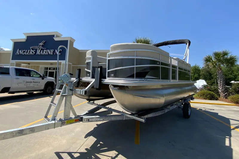 Slide: The Image of 2024 Starcraft LX20 R pontoon boat on trailer at Anglers Marine NC dealership. - 3