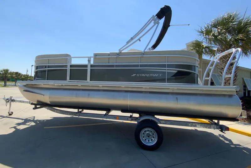 Slide: The Image of 2024 Starcraft LX20 R pontoon boat on trailer, side view. - 0