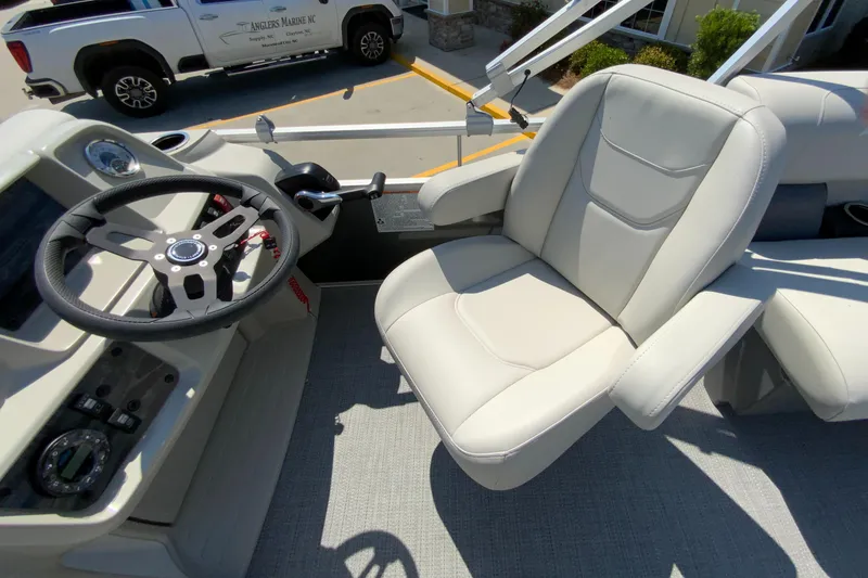 Slide: The Image of 2024 Starcraft LX20 R boat interior with steering wheel and captain's chair. - 17