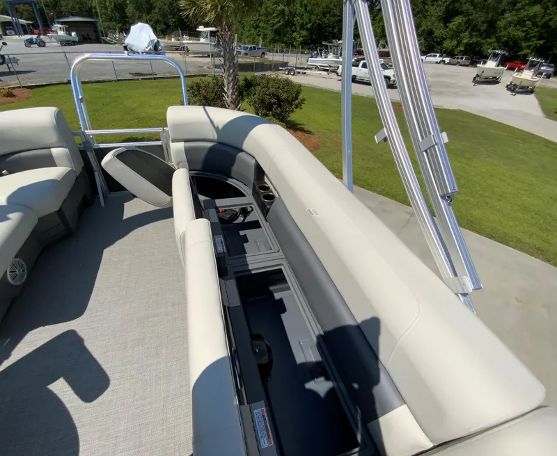 Slide: The Image of 2024 Starcraft LX20 R pontoon boat interior with open storage compartments. - 7
