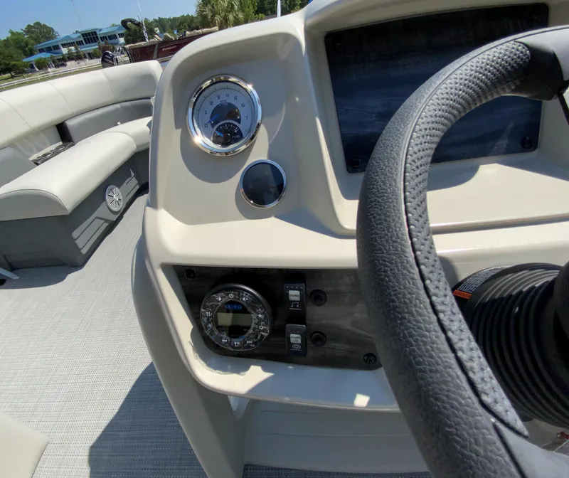 Slide: The Image of 2024 Starcraft LX20 R boat dashboard with steering wheel and gauges. - 8