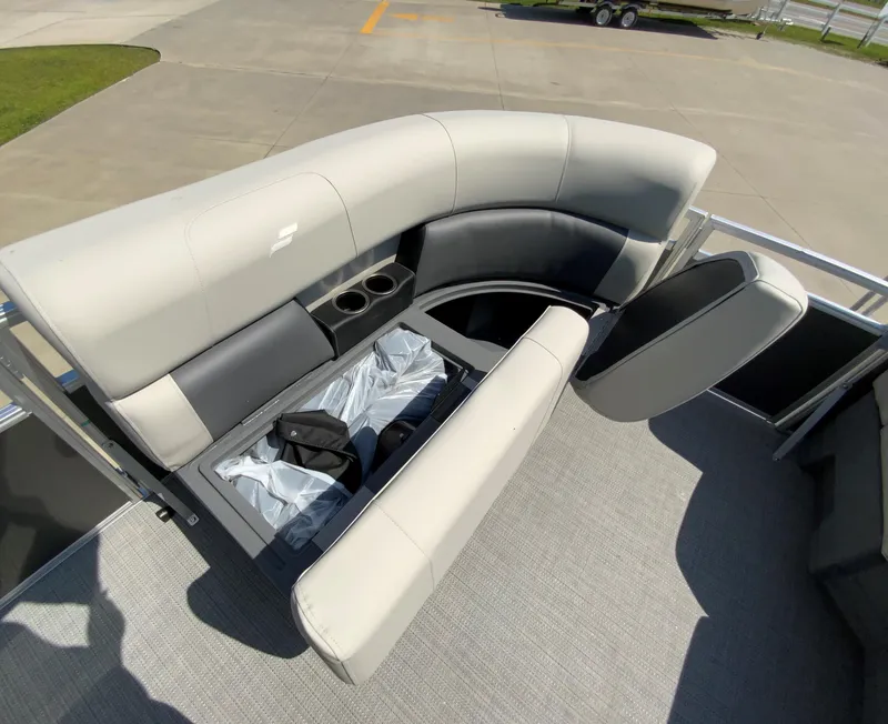 Slide: The Image of 2024 Starcraft LX20 R boat with open storage compartment and cushioned seating. - 9