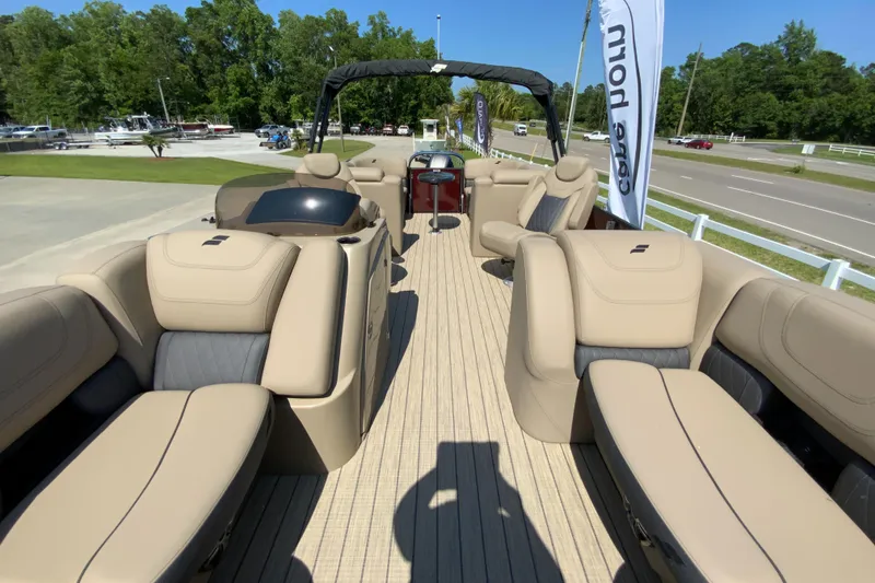 Slide: The Image of 2024 Starcraft SLS 3 pontoon boat with beige seating and spacious deck. - 20