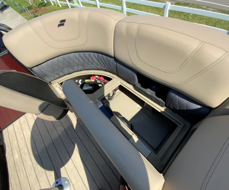 Slide: The Image of 2024 Starcraft SLS 3 boat with open storage compartment and beige seating. - 9
