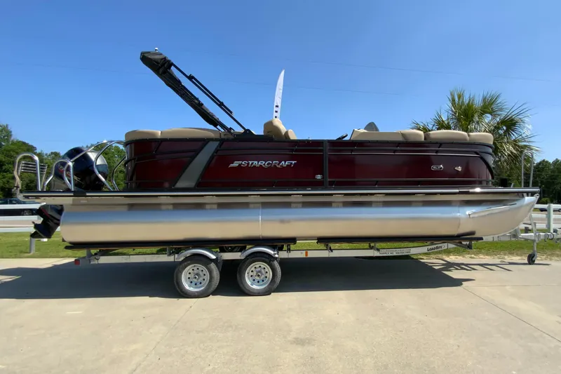The Image of 2024 Starcraft SLS 3 pontoon boat on a trailer, side view. - 0
