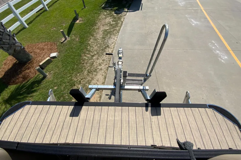 Slide: The Image of 2024 Starcraft SLS 3 boat trailer hitch and ladder on concrete driveway. - 21