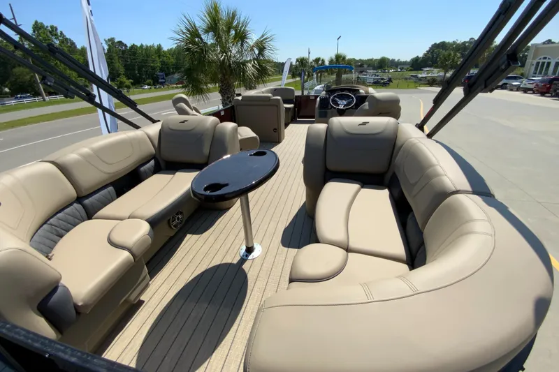Slide: The Image of 2024 Starcraft SLS 3 pontoon boat with luxurious seating and a central table. - 5