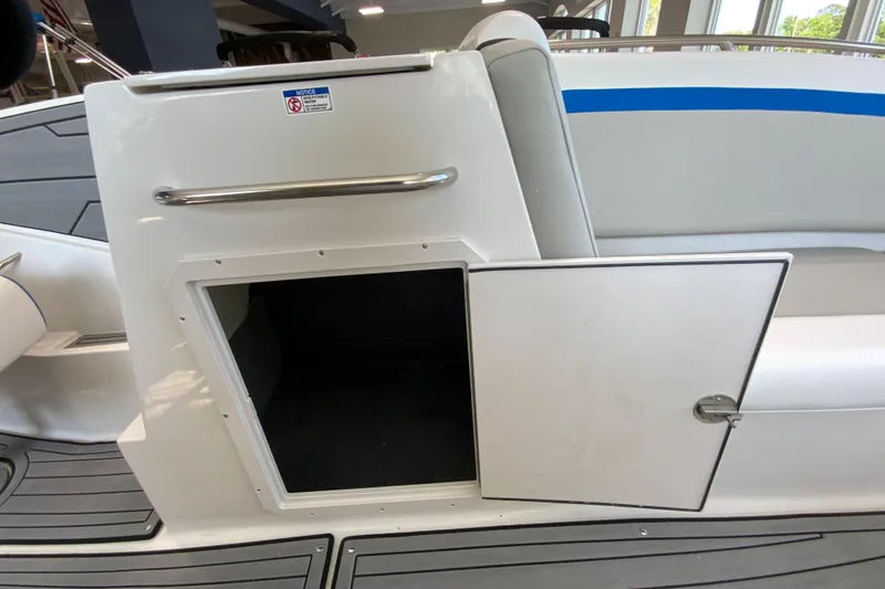 Slide: The Image of 2024 Starcraft SVX 231 boat storage compartment with open door. - 14