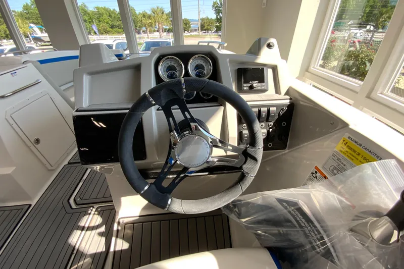 Slide: The Image of 2024 Starcraft SVX 231 boat dashboard with steering wheel and control panel. - 19
