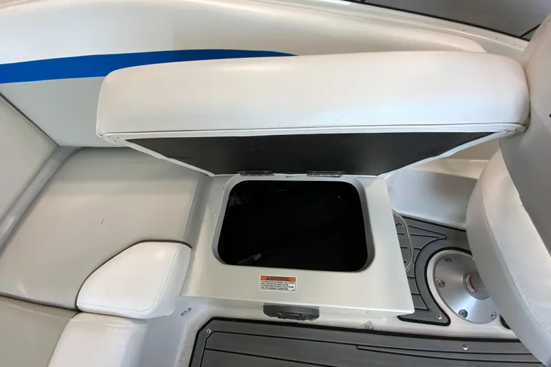Slide: The Image of 2024 Starcraft SVX 231 boat storage compartment with open seat cushion. - 23