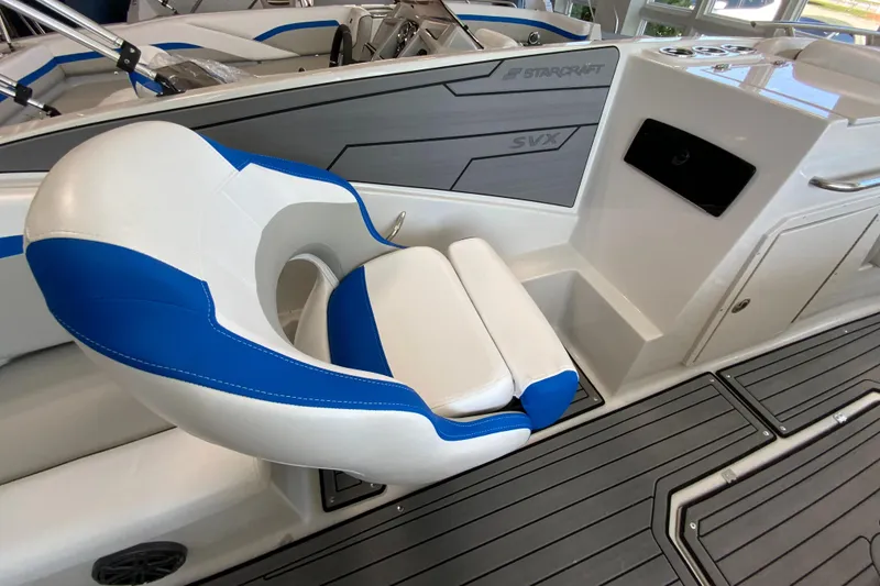 Slide: The Image of 2024 Starcraft SVX 231 boat interior with blue and white seating. - 8
